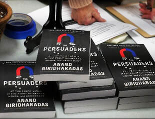 Stacks of books titled Persuaders by Anand Giridharadas