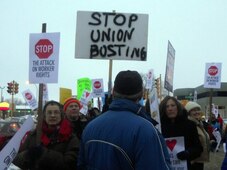 Protesters holding Stop Union Busting signs