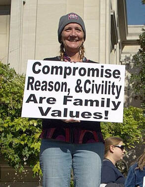  Woman holding sign that says Compromise, Reason & Civility Are Family Values