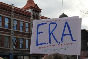  2018 Women's March in Missoula, Montana. Person holding a sign with the letters E.R.A written in blue on a white background.