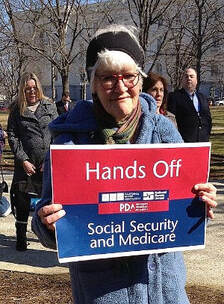 Nurse holding red white and blue sign - Hands Off Social Security and Medicare 