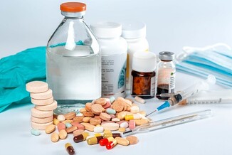 Assorted healthcare items: pills, syringe, rubber gloves, etc.