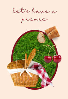 Picnic basket on grass with bread and cherries