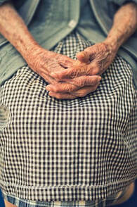Older woman with hands in her lap
