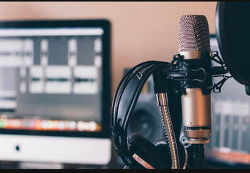Microphone and headphones indicating a radio studio