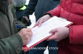 People gathering signatures on a petition or initiative