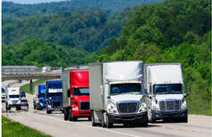 Big trucks moving down a freeway