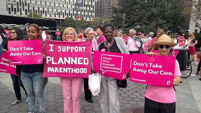 Women holding signs for Planned Parenthood, “I support Planned Parenthood”